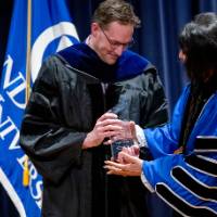 President Mantella presents man with glass trophy award